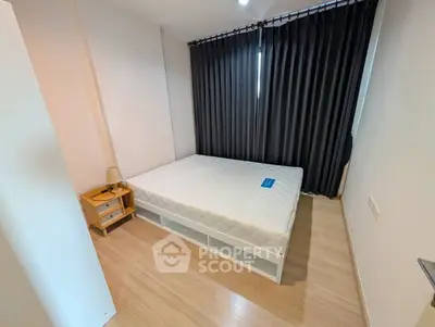 Modern bedroom with minimalist design featuring a comfortable bed and sleek wooden flooring.