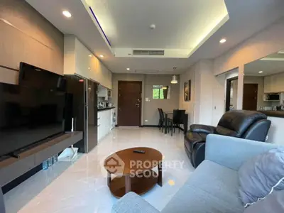 Spacious modern living room with sleek furniture and open kitchen layout in a stylish apartment.