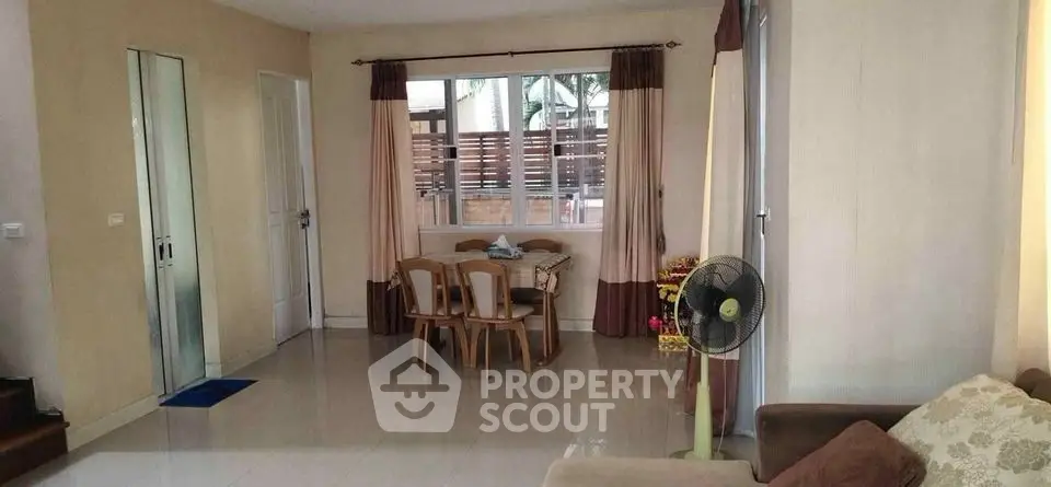 Spacious living room with modern decor and large window for natural light.
