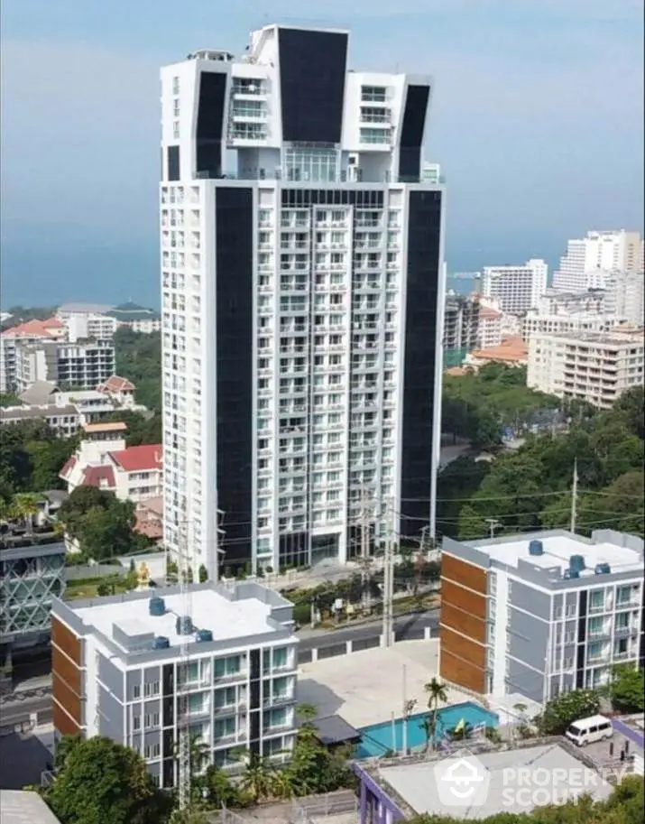 Majestic high-rise condominium tower with ocean views, surrounded by lush greenery and modern amenities, offering a luxurious urban living experience.