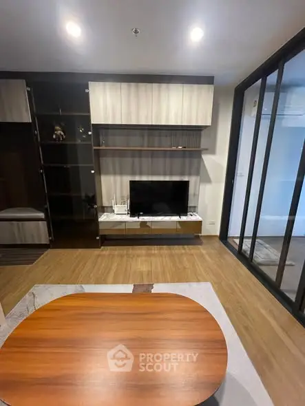 Modern living room with sleek TV unit and wooden flooring