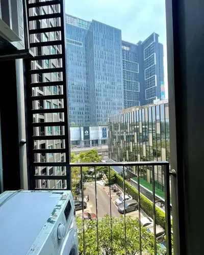 Urban balcony view with modern high-rise buildings and cityscape