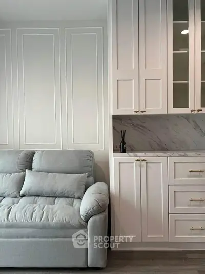 Elegant living room with plush sofa and stylish cabinetry, perfect for modern living.