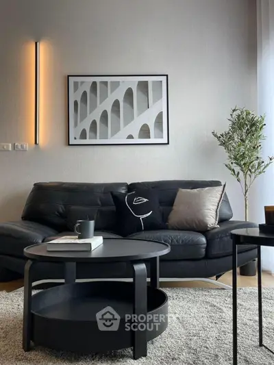 Modern living room with sleek black leather sofa and stylish decor