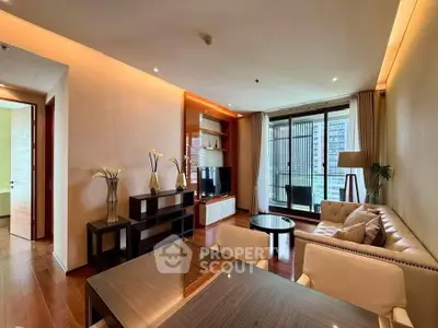 Luxurious living room with elegant decor and large windows offering city views.
