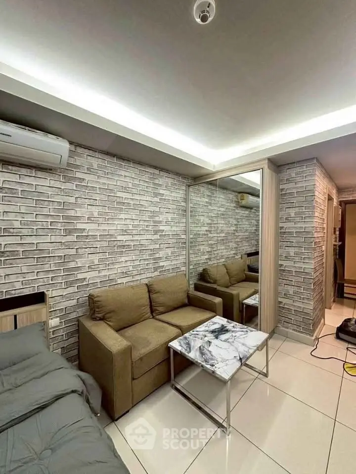 Modern living room with exposed brick wall, cozy sofa, and marble coffee table in stylish apartment.