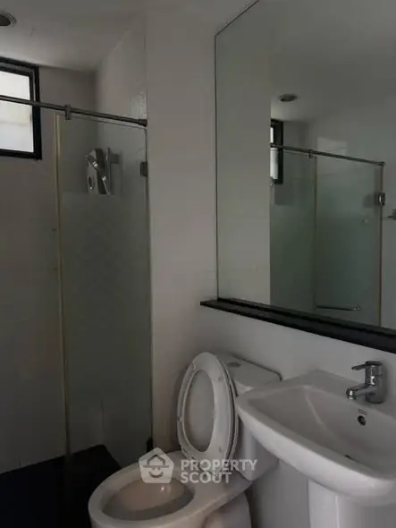 Modern bathroom with glass shower and sleek fixtures