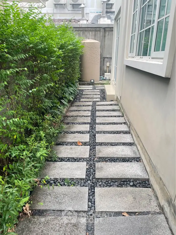 Charming garden pathway with modern stone design and lush greenery