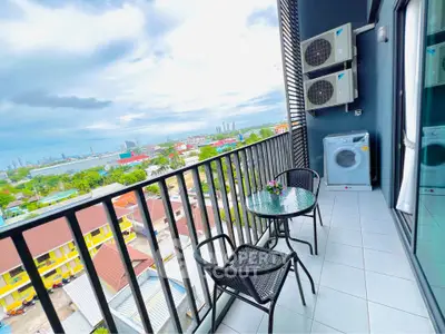 Stunning balcony with city view, featuring outdoor seating and modern appliances, perfect for relaxation.