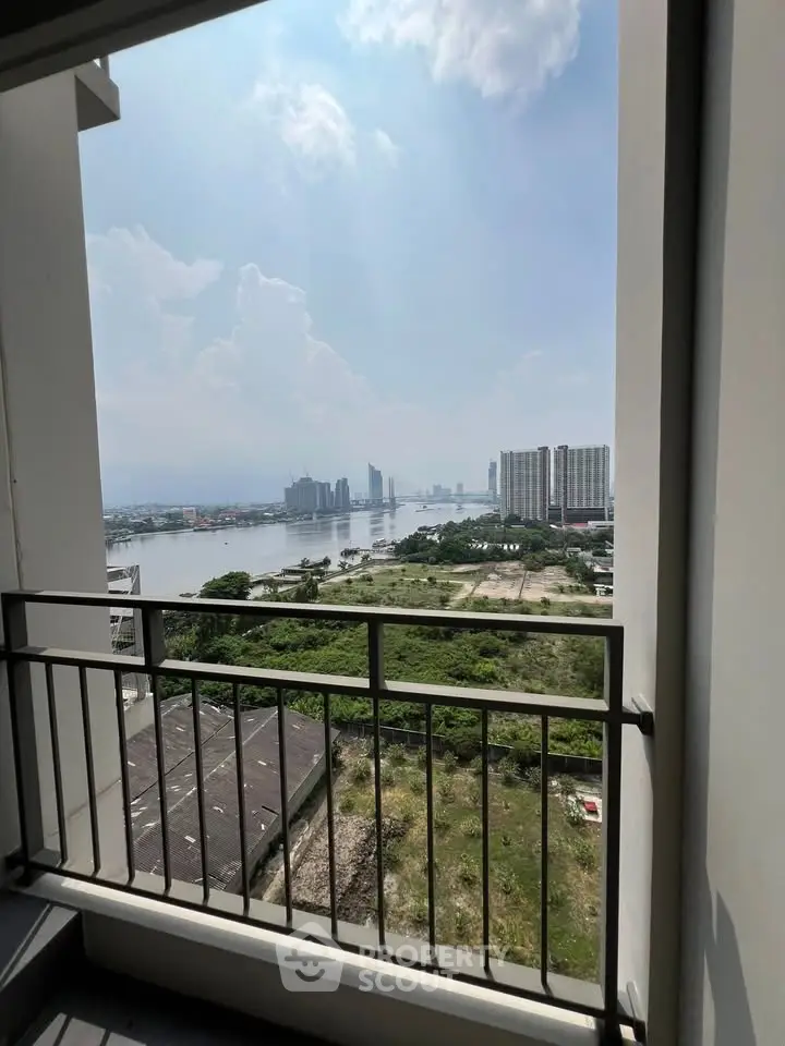 Stunning river view from high-rise balcony with cityscape in the background, perfect for urban living.