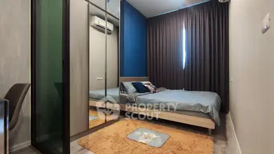Modern bedroom with mirrored wardrobe and cozy decor in stylish apartment.