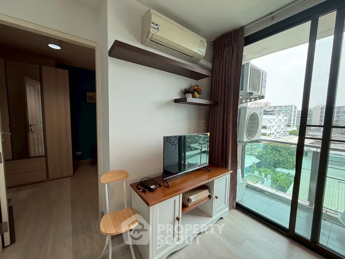 Modern living room with air conditioning and balcony view in urban apartment