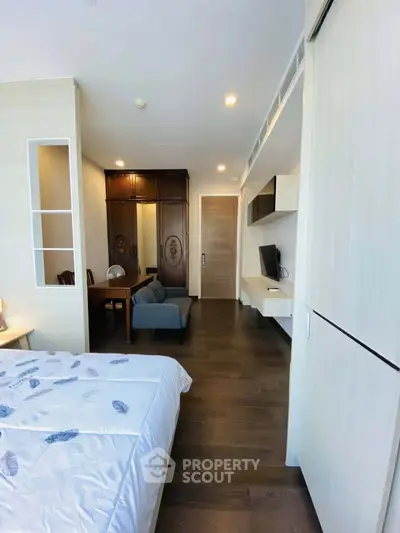 Modern bedroom with elegant decor and built-in storage in a luxury apartment.