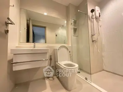 Modern bathroom with sleek fixtures and glass shower enclosure