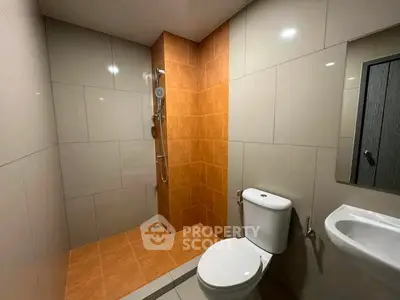 Modern bathroom with sleek tiles and walk-in shower