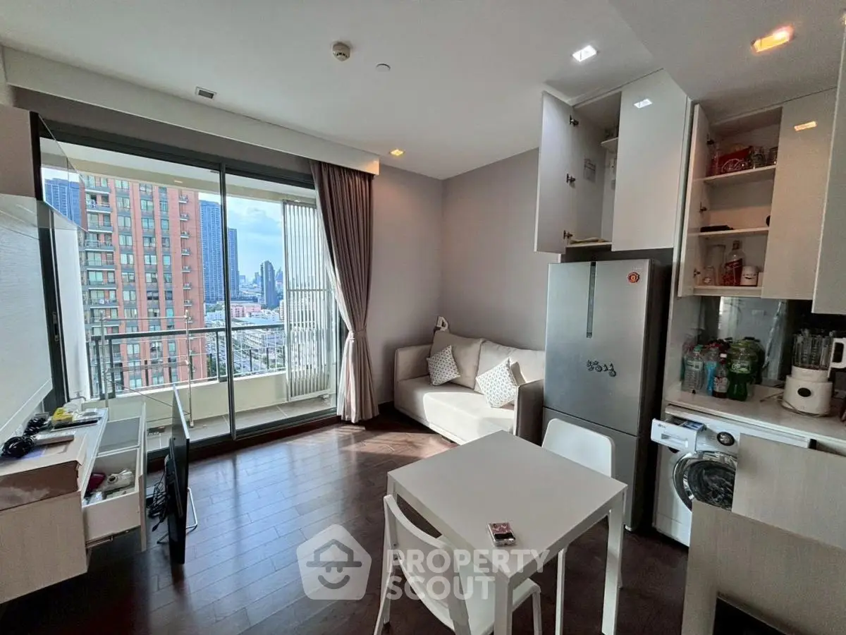 Modern living room with open kitchen and city view balcony in high-rise apartment