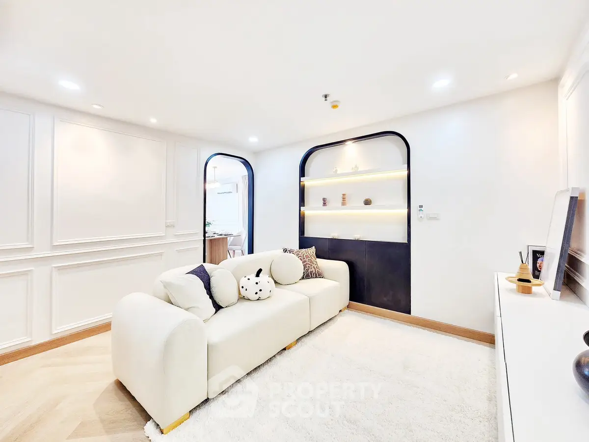 Elegant living room with modern white sofa and stylish wall shelving