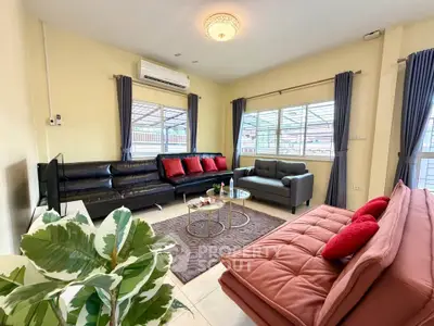 Spacious living room with modern furniture and large windows for natural light.