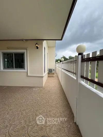 Spacious balcony with elegant railing and scenic view, perfect for relaxation.