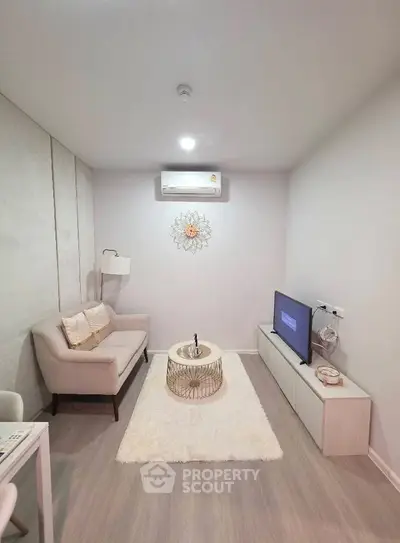 Cozy modern living room with stylish decor and air conditioning, perfect for relaxation and entertainment.