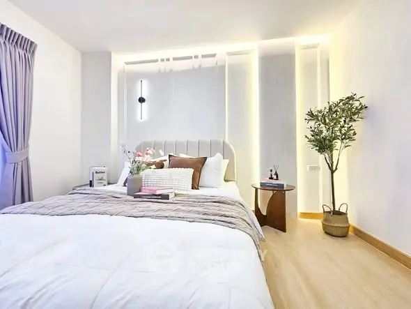 Elegant bedroom with modern decor and cozy ambiance, featuring stylish lighting and a comfortable bed.