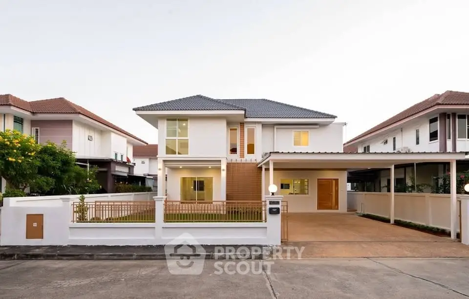 Stunning modern two-story house with spacious driveway and elegant facade.