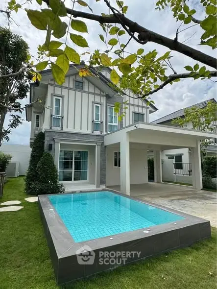 Charming two-story house with private pool and lush garden, perfect for family living.