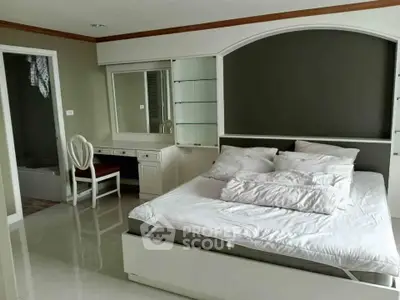 Spacious bedroom with elegant decor and attached study area, perfect for comfort and productivity.