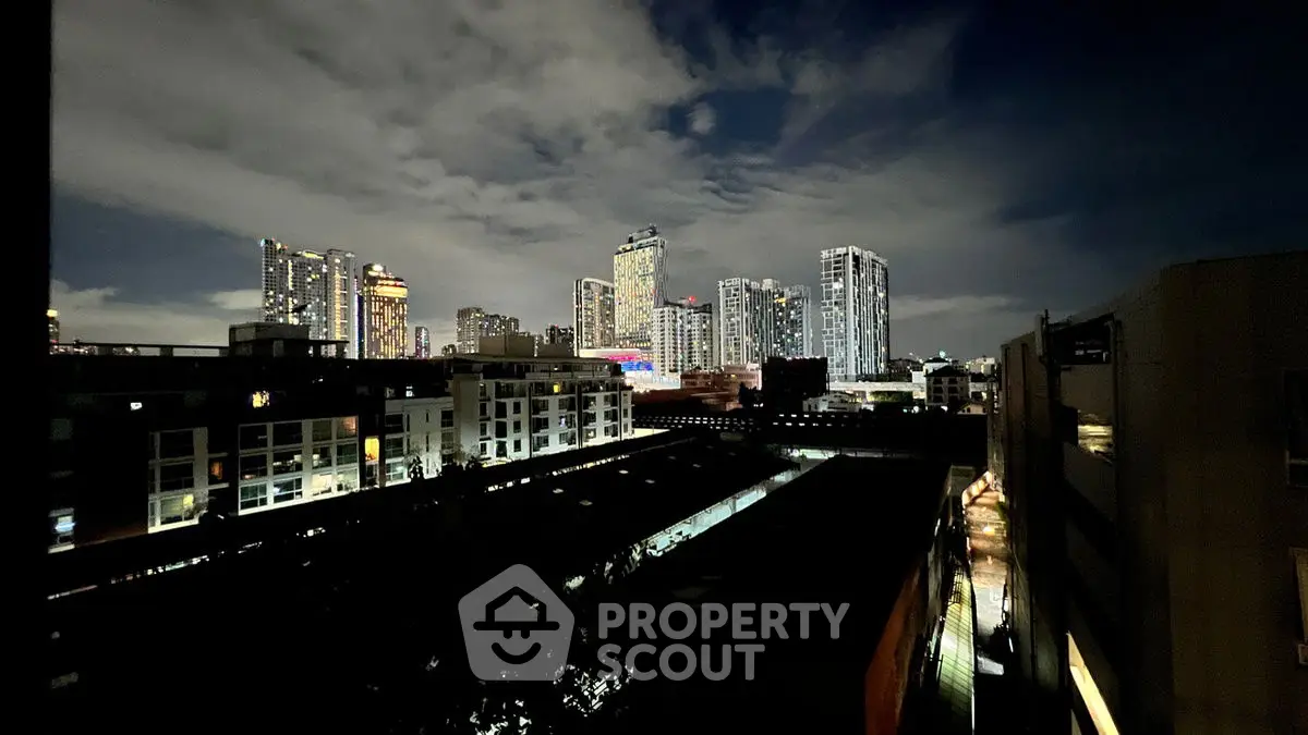 Stunning city skyline view at night with illuminated skyscrapers and urban landscape.