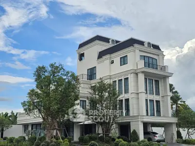 Elegant multi-story building with lush landscaping and modern architectural design.