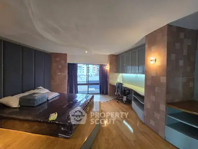 Spacious bedroom with modern design and balcony access in urban apartment