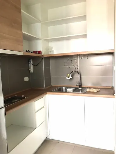 Modern compact kitchen with sleek cabinetry and stainless steel sink