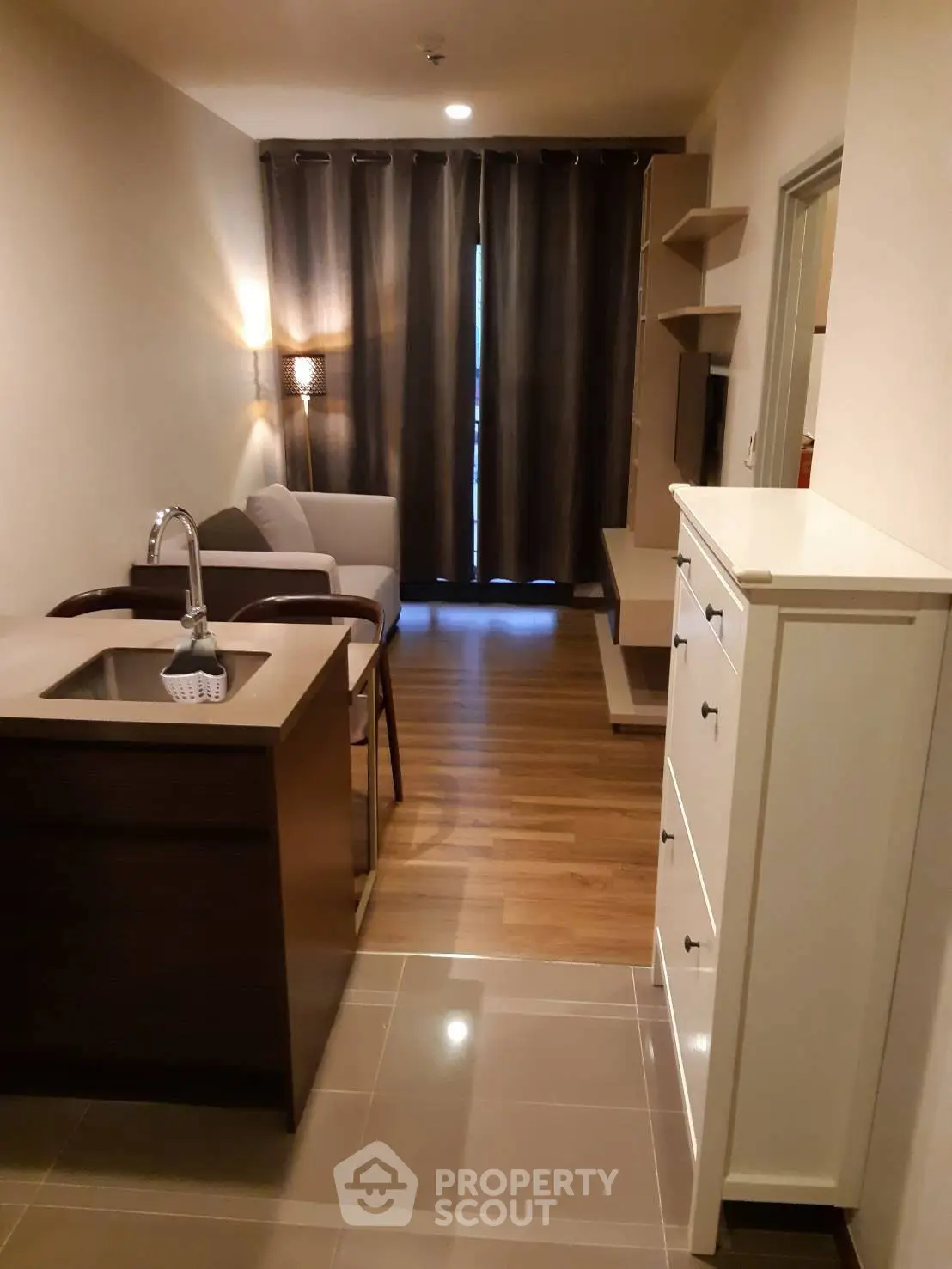 Modern apartment interior with cozy living area and compact kitchen design.