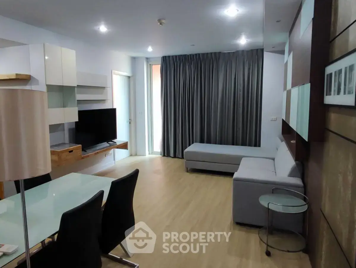 Modern living room with sleek furniture and natural light, perfect for comfortable living.