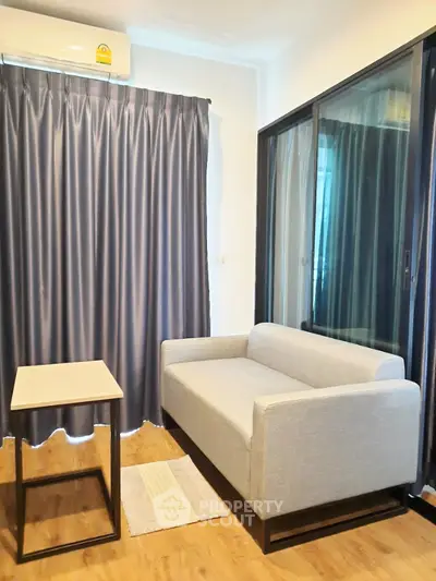 Modern living room with sleek sofa, stylish curtains, and wooden flooring in a cozy apartment.