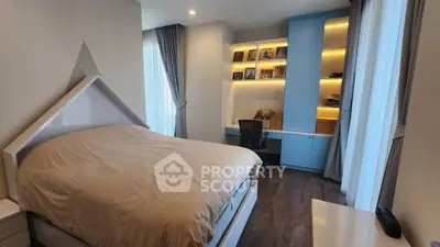 Modern bedroom with built-in desk and shelving, featuring elegant lighting and floor-to-ceiling windows.