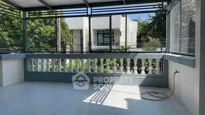 Spacious balcony with modern railing and garden view