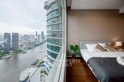 Luxurious bedroom with stunning river view in modern high-rise apartment.