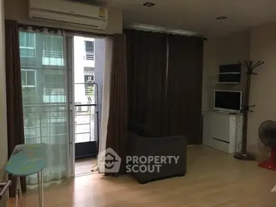 Cozy living room with balcony access in modern apartment