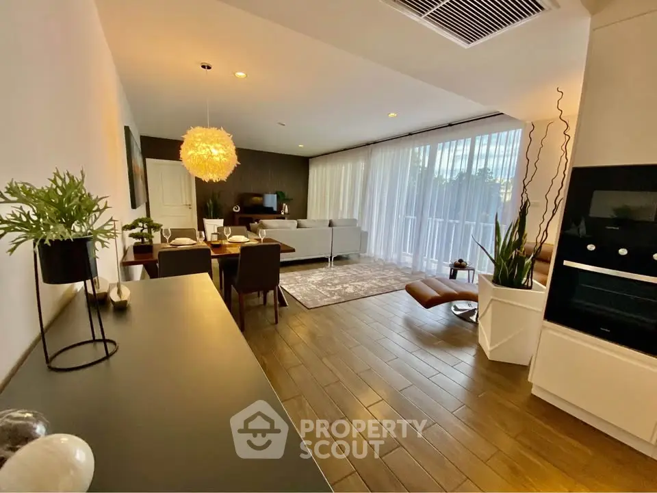 Spacious modern living room with elegant decor and large windows for natural light.
