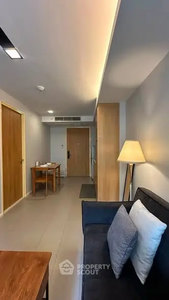 Modern living room with sleek furniture and ambient lighting in a stylish apartment.