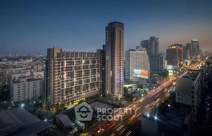 Stunning cityscape view of modern high-rise buildings at dusk with vibrant city lights.
