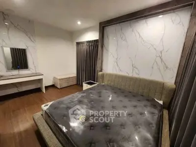 Luxurious bedroom with elegant marble accents and modern furnishings