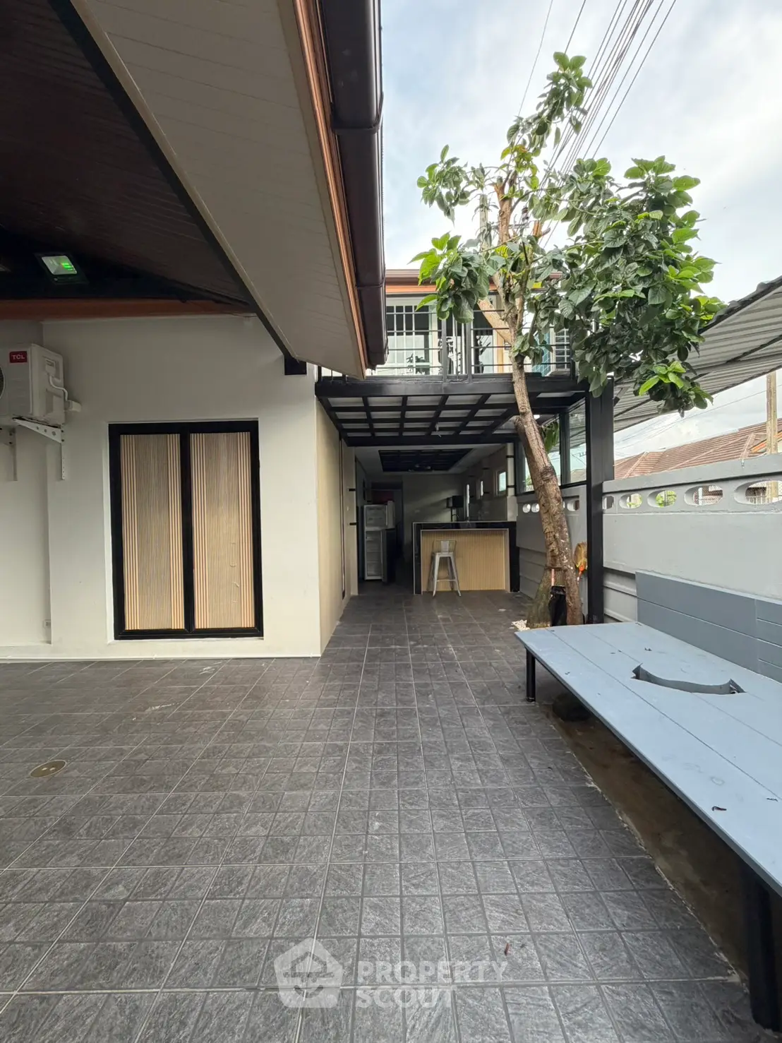 Modern outdoor patio with sleek tile flooring and stylish bench seating
