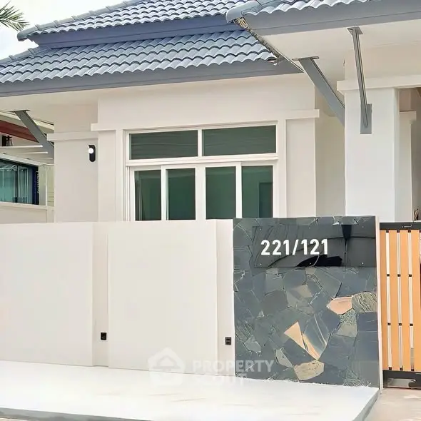 Modern house exterior with stylish facade and unique address display.