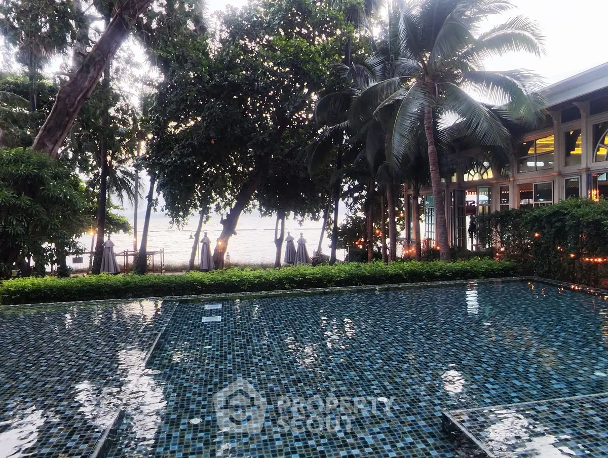 Stunning beachfront pool with lush greenery and ocean views