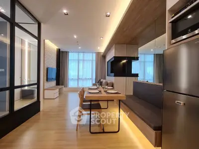 Modern open-layout kitchen and dining area with sleek design and natural light.