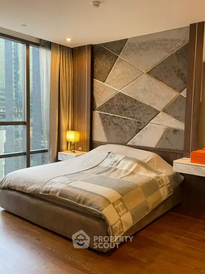 Luxurious bedroom with modern decor and large window offering city views