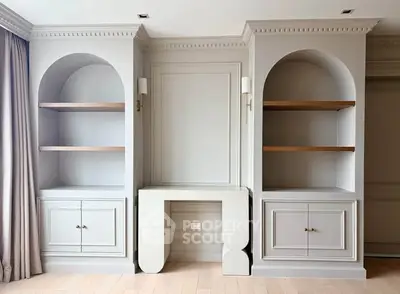 Elegant built-in shelves with classic molding in a sophisticated living room setting.