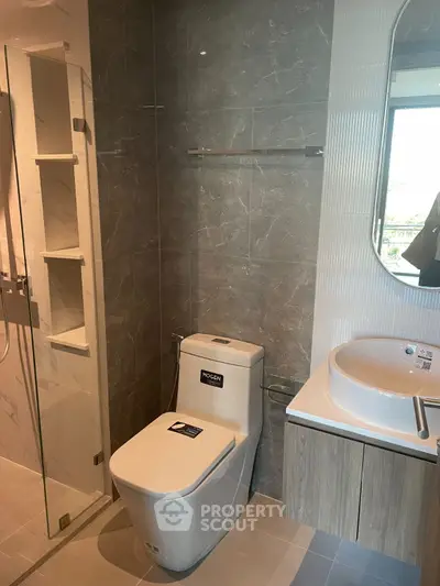 Modern bathroom with sleek fixtures and glass shower enclosure